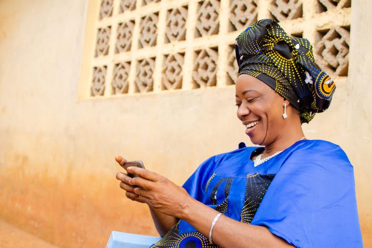 Adult woman looks at her mobile phone in Niger