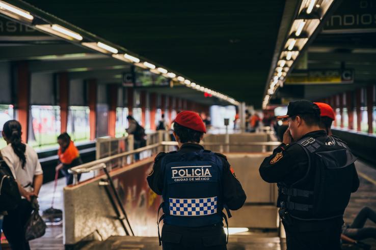 Two police officers patrol transit building in Mexico City