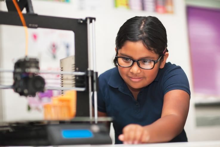 A young female student learning as she works on task in school laboratory in the United States