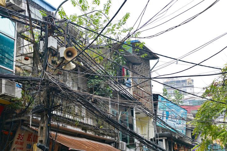Pole with many electricity cables in Hanoi, Vietnam