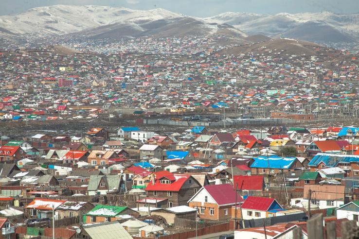 Colorful houses in front of mountain range in Mongolia