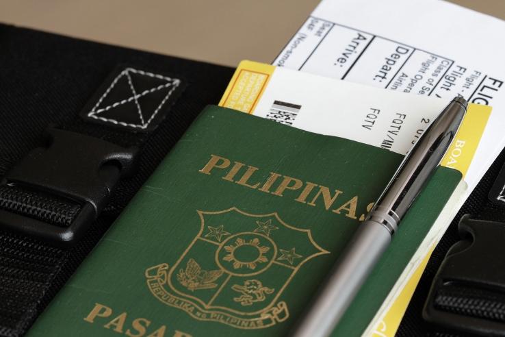 Pilipinas passport with flight ticket inside