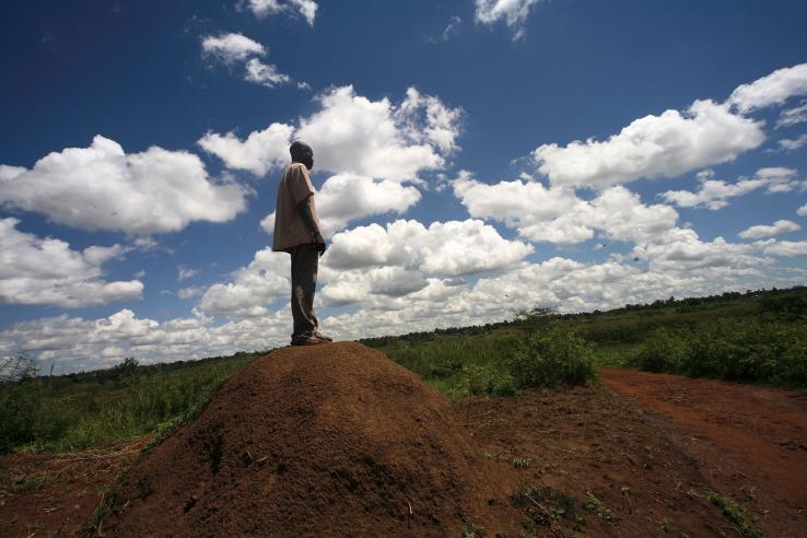 A man is looking out over the land in Kenya. 
