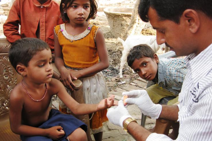 Child having his finger pricked in Bihar, India