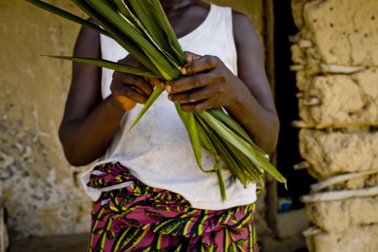 A woman holds harvested crops.