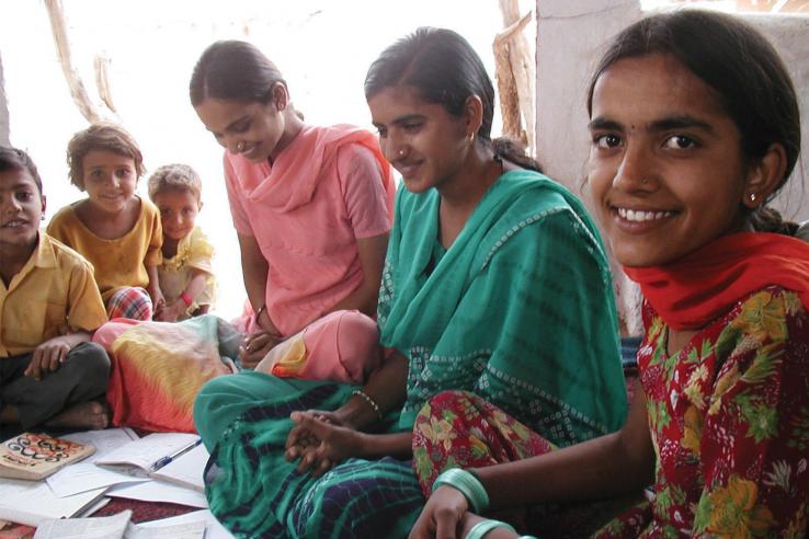 Young women seated looking at papers