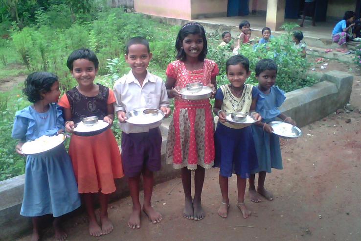 Schoolchildren in Orissa, India pose with their mid-day meals.
