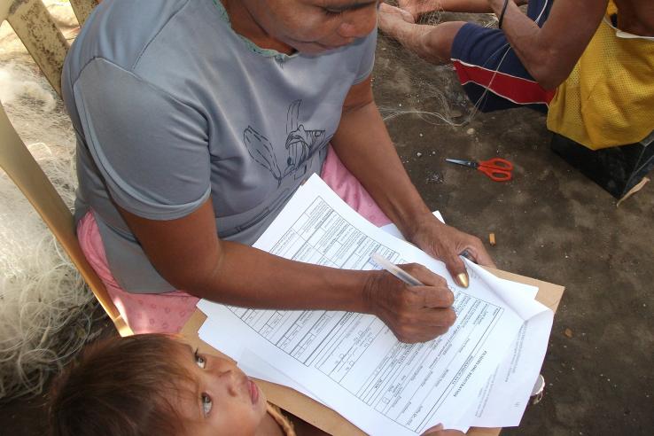 Woman fills out paper work in Philippines