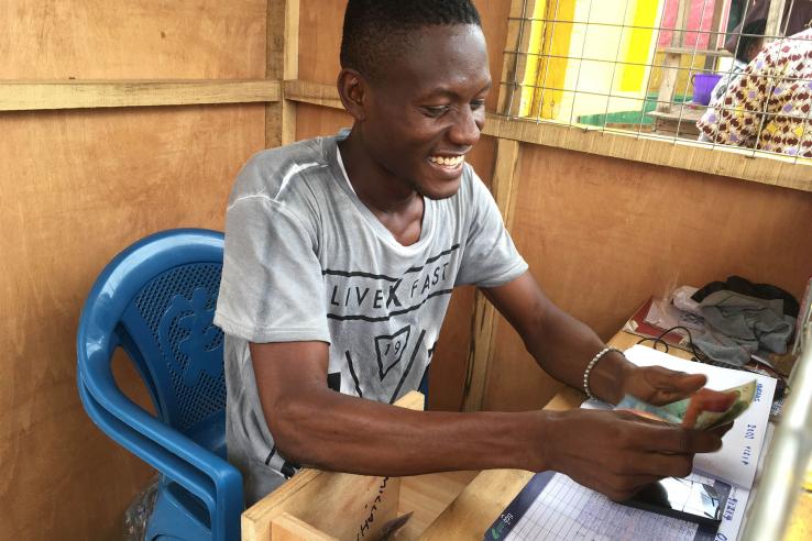 Man smiles while counting money