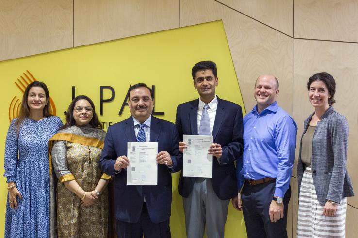 a group of people posing for the camera holding a certificate