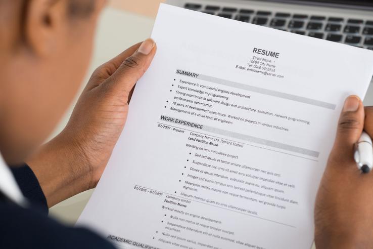 Person holds resume