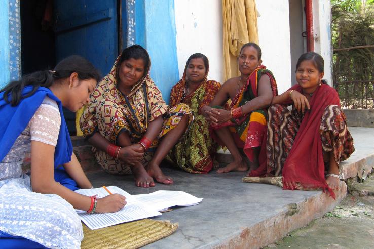 Group of women sit as a woman takes notes