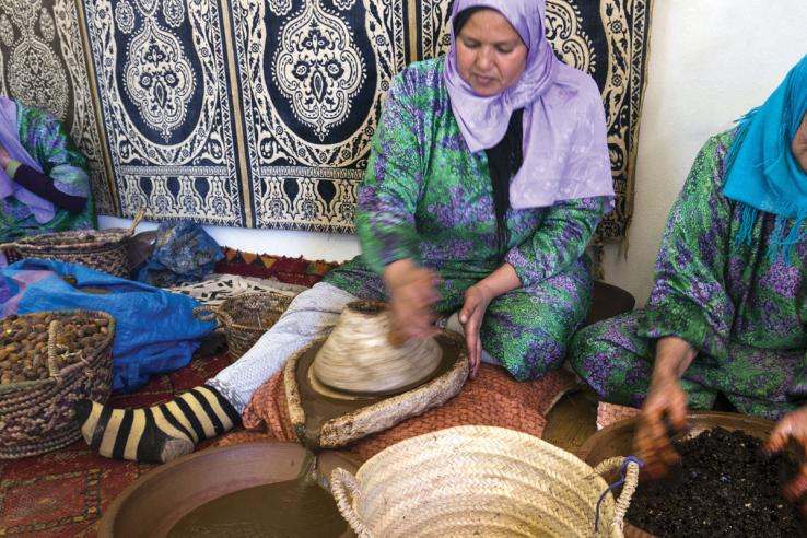 Women processing fruit in baskets