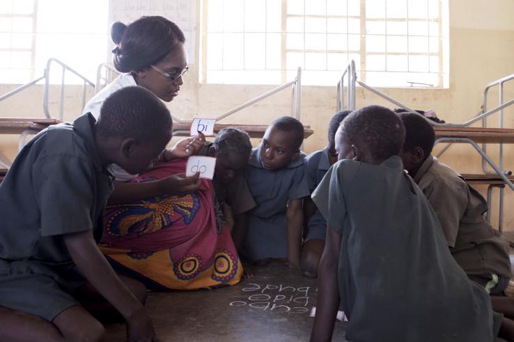 Woman teaching students in Africa