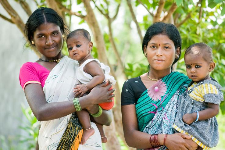 Two mothers hold infants