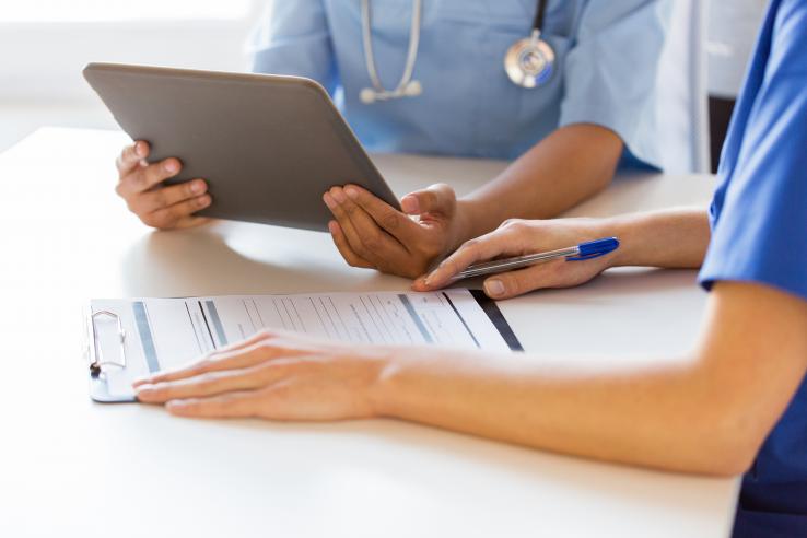 Health care workers filling out forms