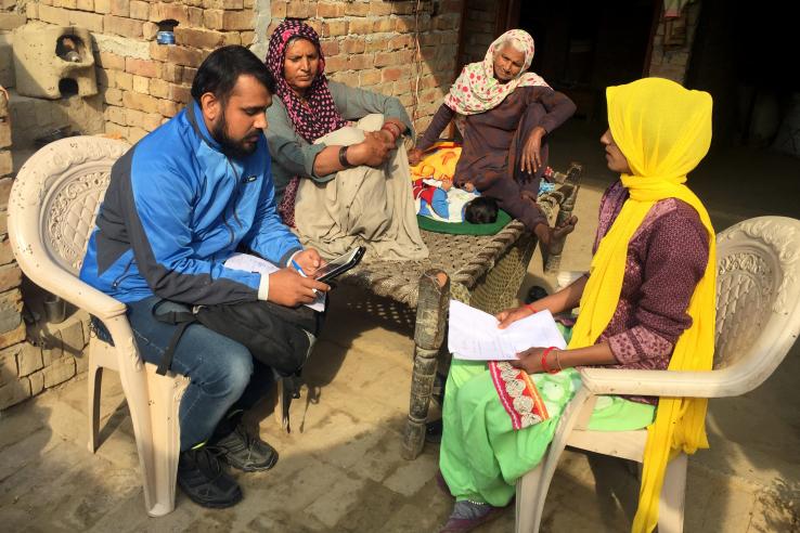 A man with a tablet talking to a woman