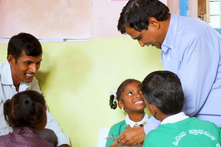 Two male school teachers and three students