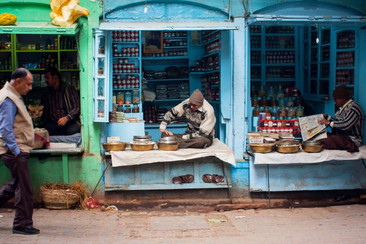 Vendors sell good from multi-colored stalls.