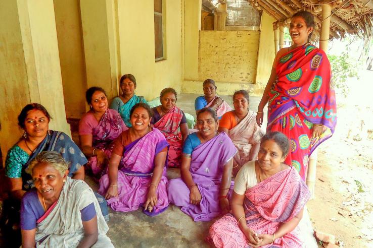 Women in India sitting on the floor for a focus group discussion.