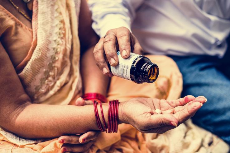 women holding hand out to receive medication