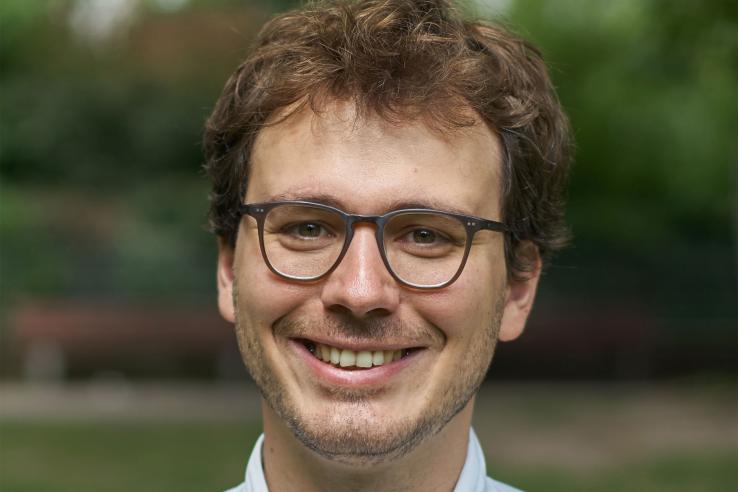 A close-up of a man smiling at the camera