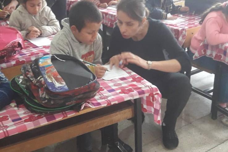 Sule Alan talks to children in a classroom in Turkey.