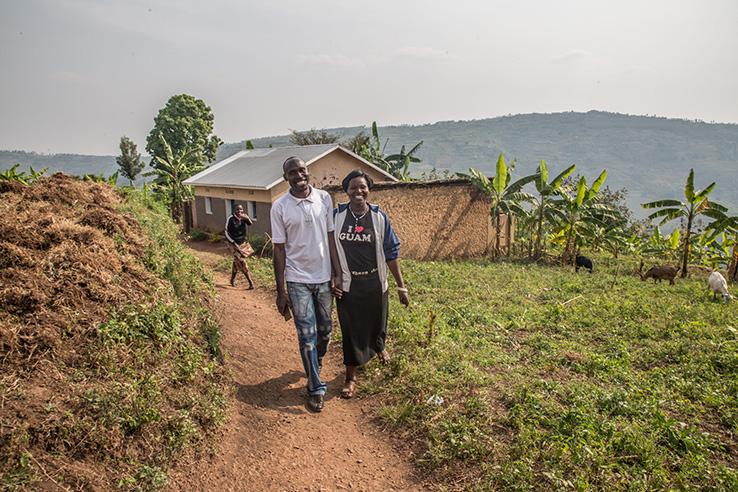 A man and woman walk together holding hands