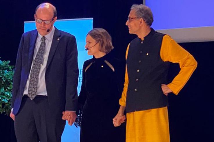 Nobel laureates Michael Kremer, Esther Duflo, and Abhijit Banerjee on the Nobel stage in Stockholm