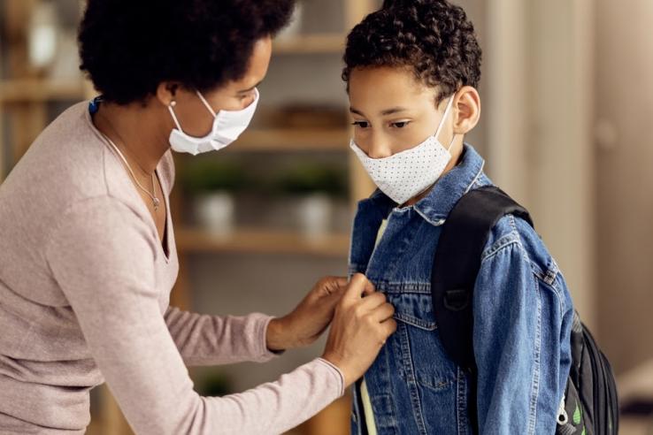 Parent gets child ready for school.