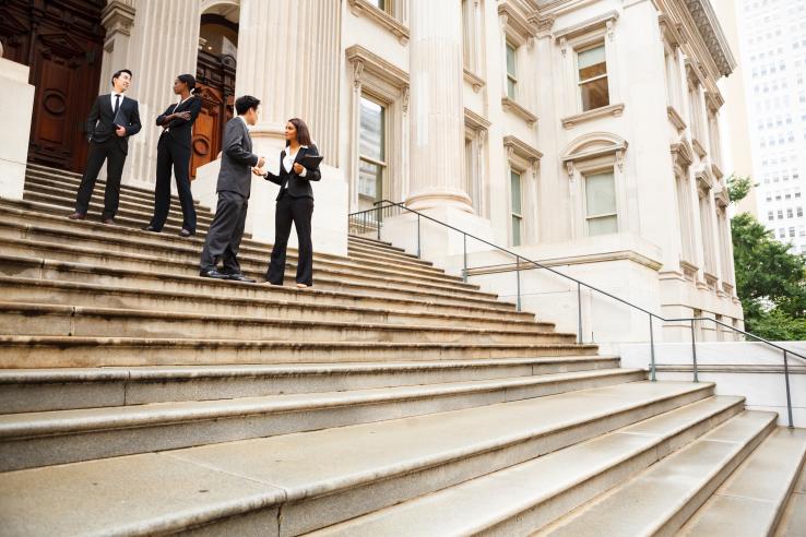 Government officials stand on steps