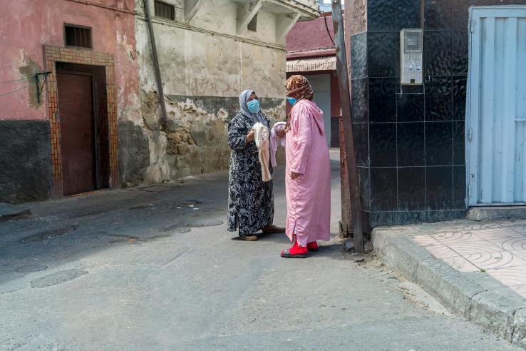 Two women wearing masks chat near their houses during the Covid-19-related state of emergency in Casablanca, Morocco.
