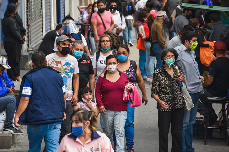 A crowd of people wearing face masks