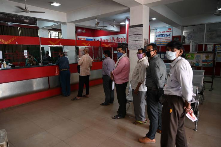 People wait in line to make a transaction