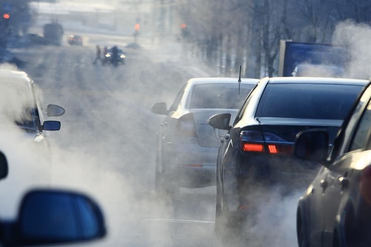 Cars emitting fumes.