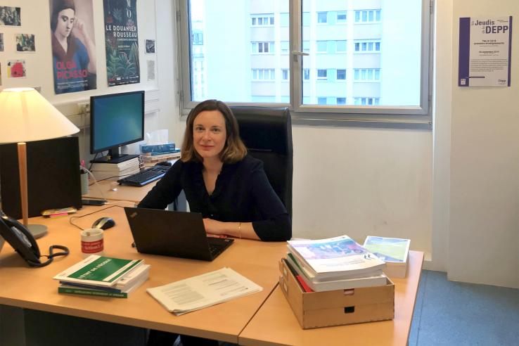 Axelle Charpentier sits in behind a desk in her office.