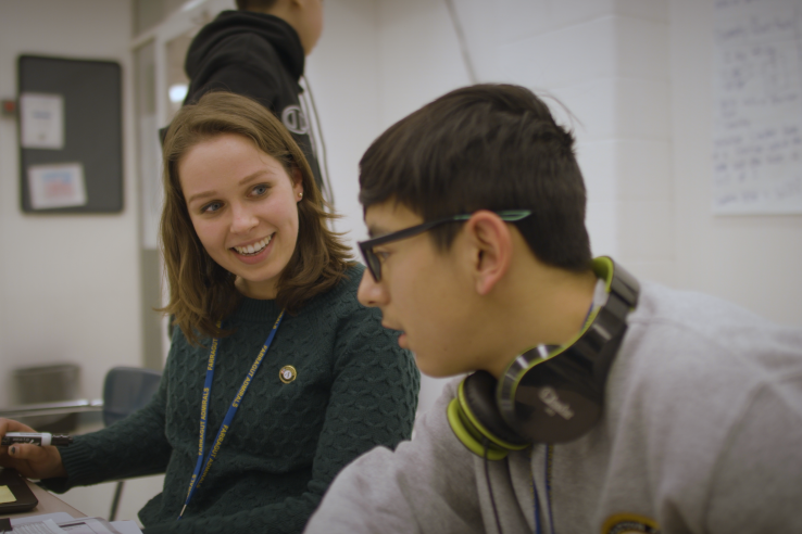 A woman tutors a high school boy