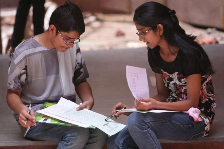 A young man and young woman studying together
