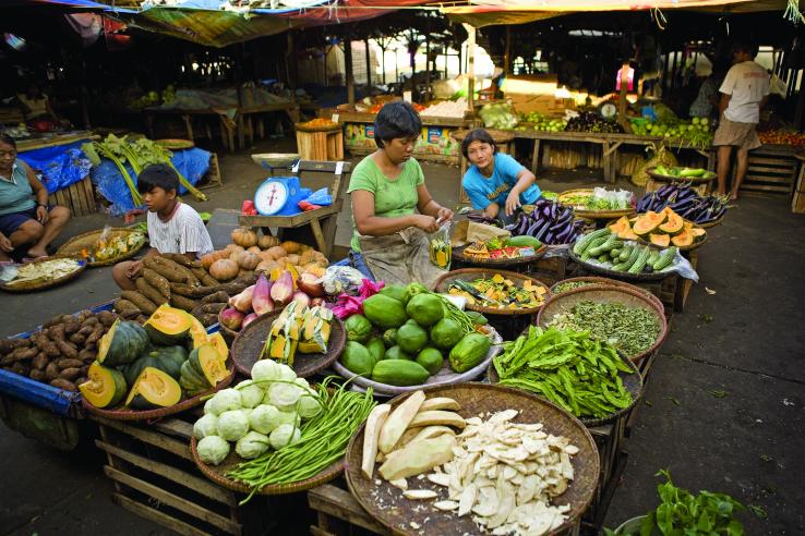 Women and children sell product in an open market in the Philippines.