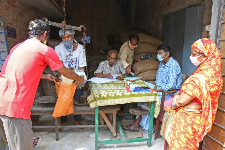 Beneficiaries collect rations from a government shop during the covid-19 pandemic