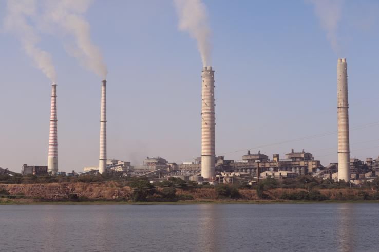 Smoke stacks billowing smoke in India