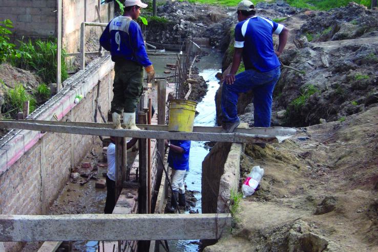 Construction workers in Mexico work on constructing a road.