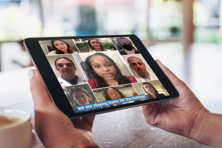 A person holds a tablet showing a Facebook ad featuring the images of doctors and nurses. 