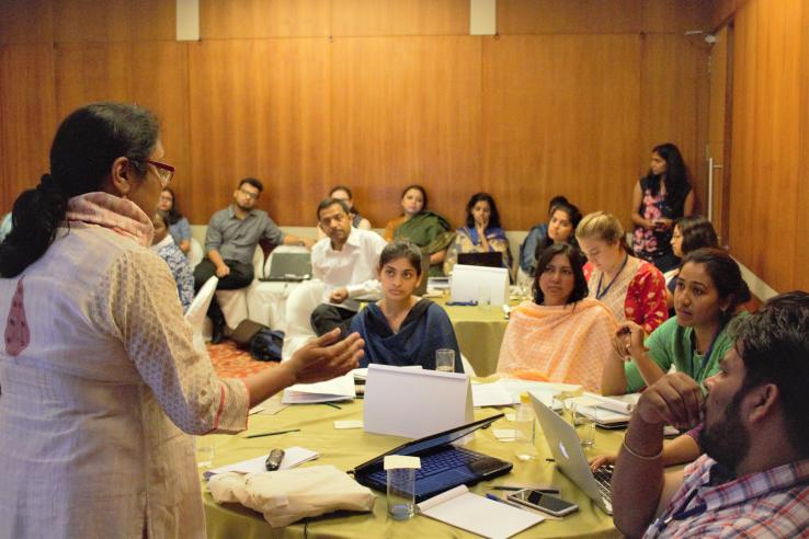 A lecturer speaks to a room of participants