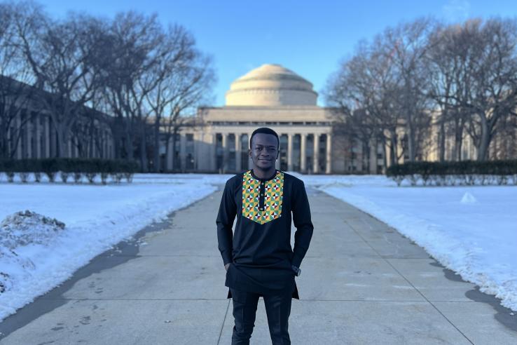 Chuka Ezeoguine stands in front of Killian Court on the MIT campus in Cambridge, MA.