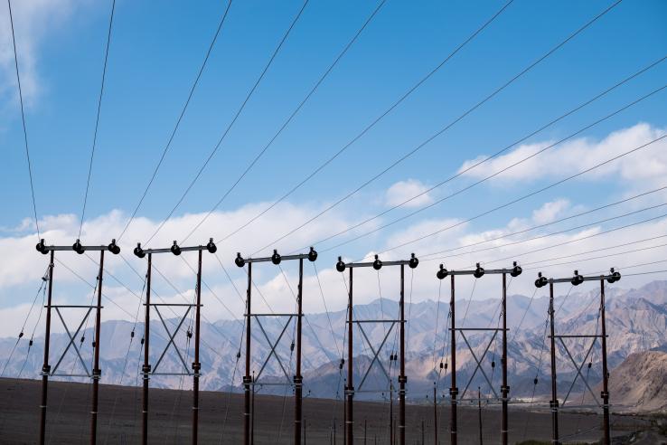 Electric poles and cables with blue sky background