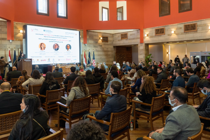 A crowd attending the Egypt Impact Launch listen to a presentation.