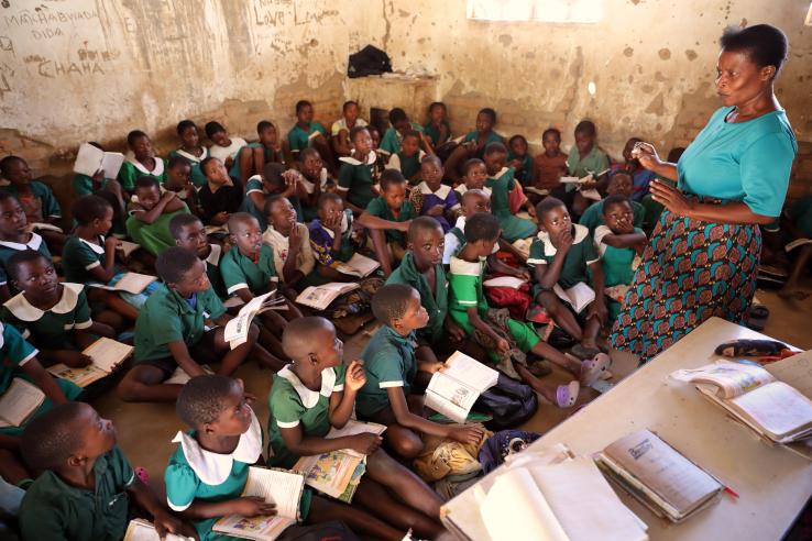 Children study in a classroom.