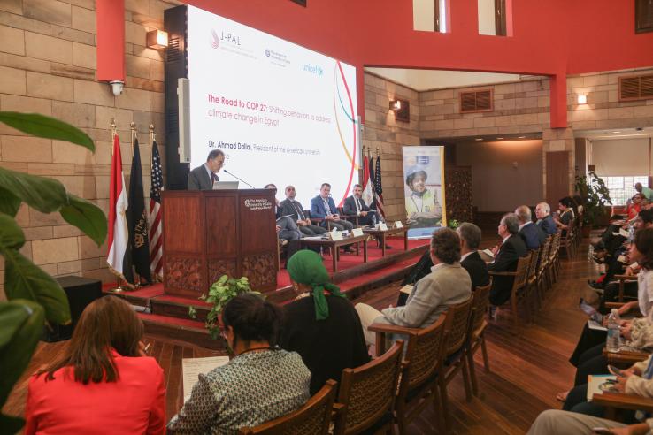 Attendees are watching a panel of four people for the COP27 in Egypt