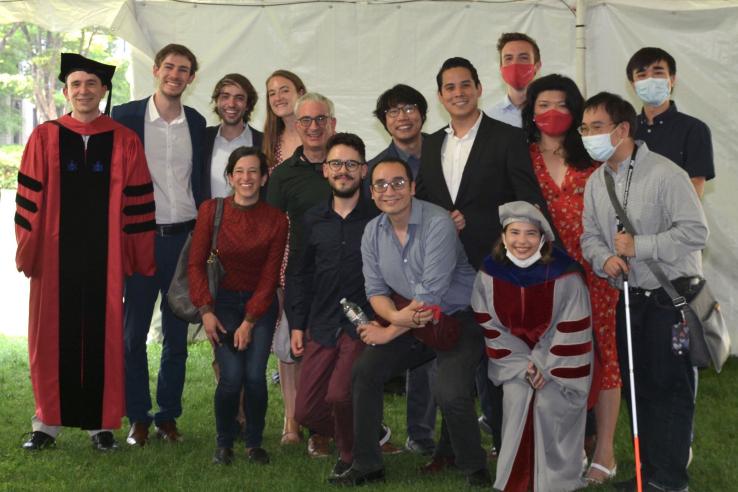 A group of DEDP students and faculty pose for a photo together on graduation day.